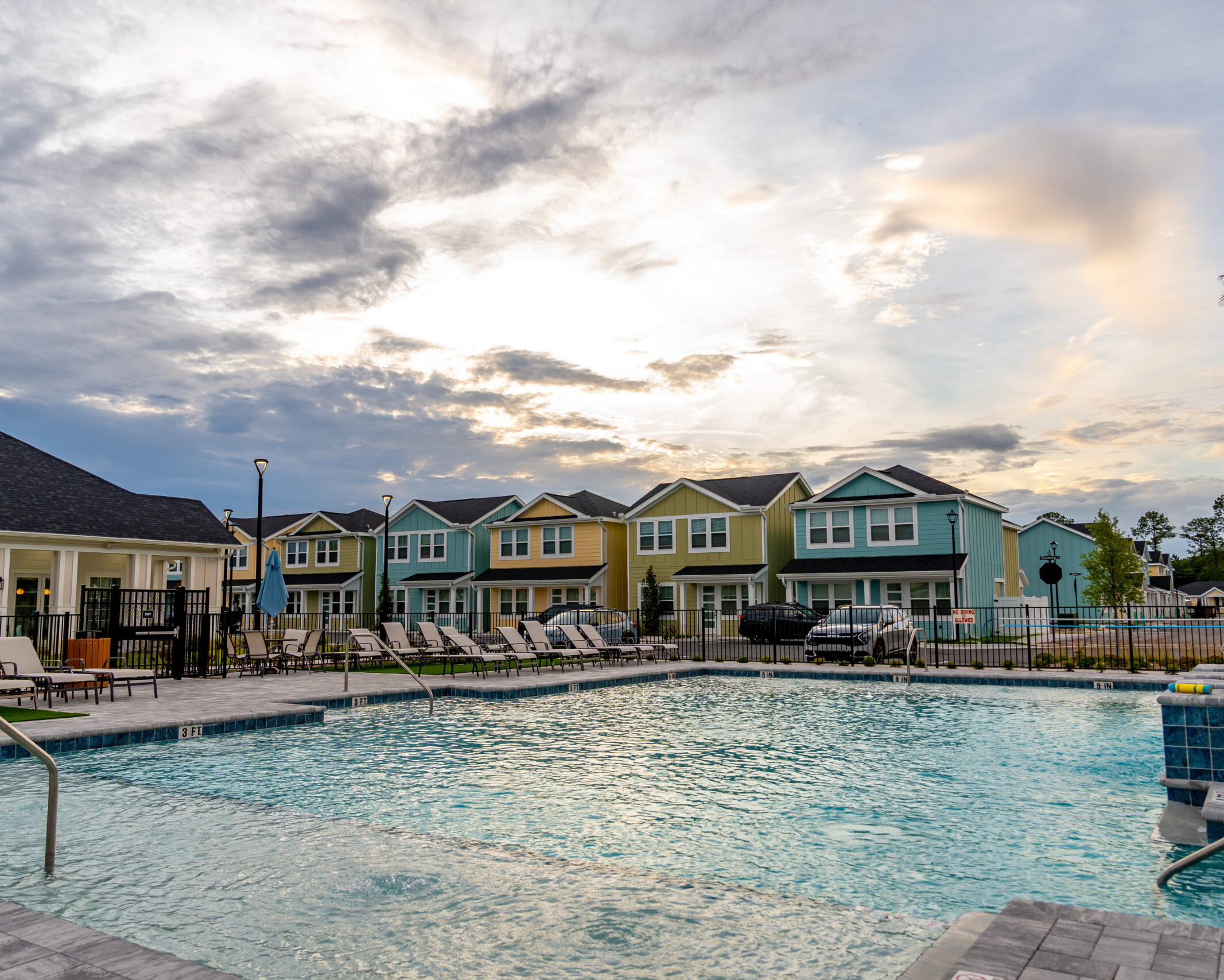 JLM Living's The Eleanor Daytona Beach swimming pool with houses behind it