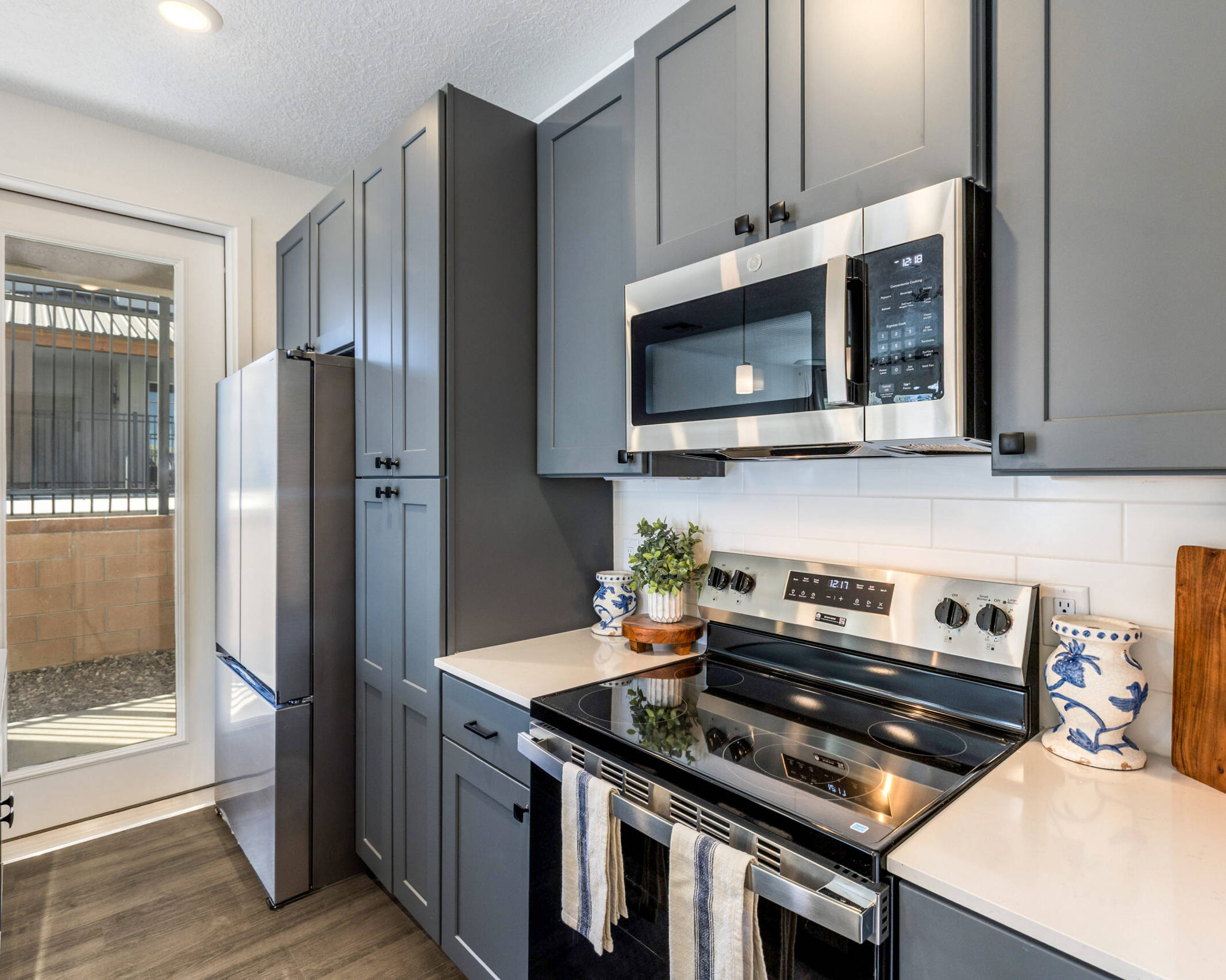 closer view of stainless steel appliances and dark gray cabinets