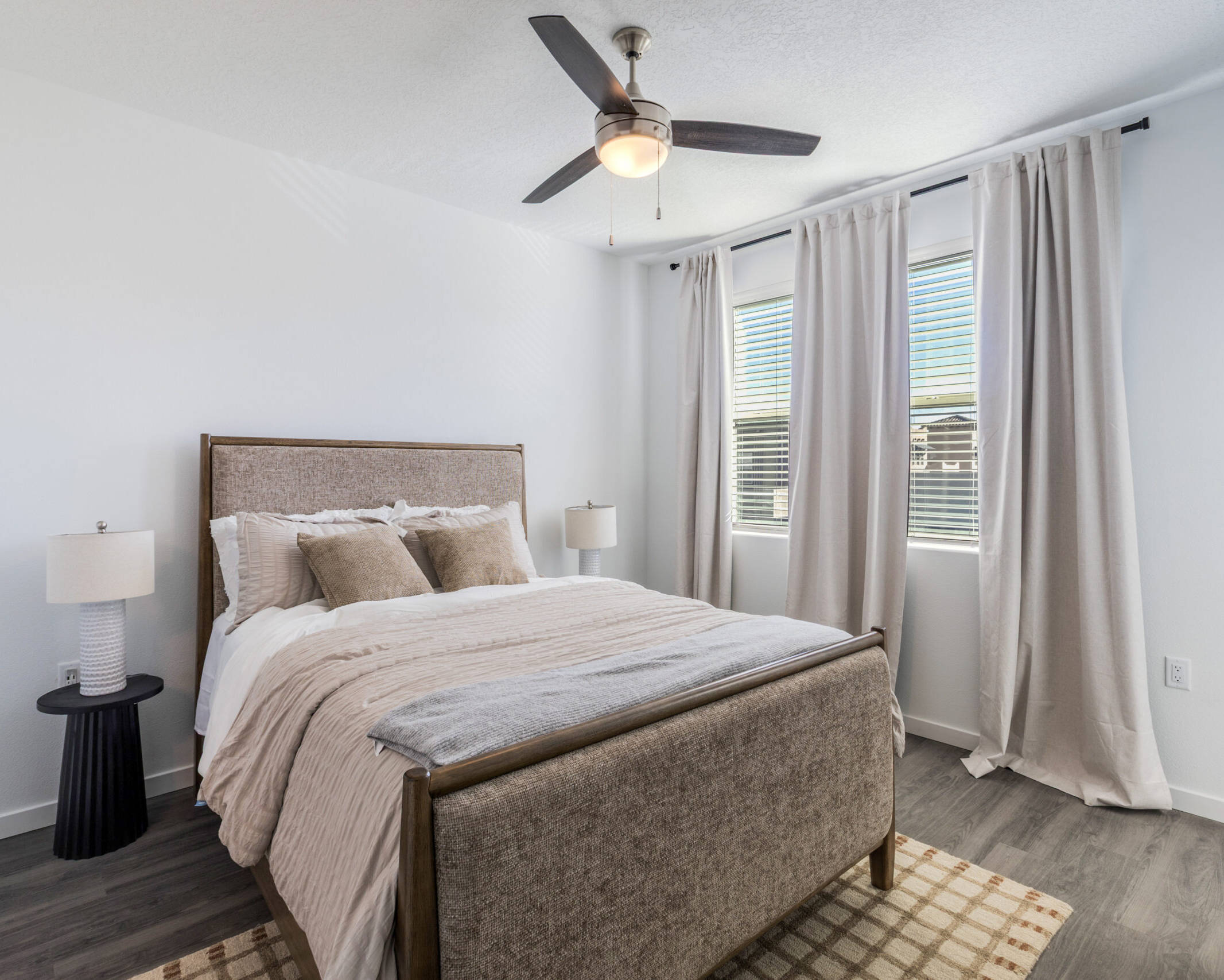 modern bedroom quipped with windows and ceiling fan