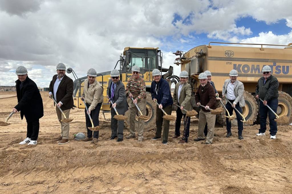 row of men with shovels at a groundbreaking event