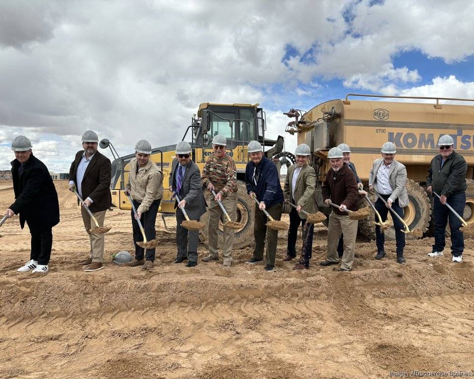 row of men with shovels at a groundbreaking event