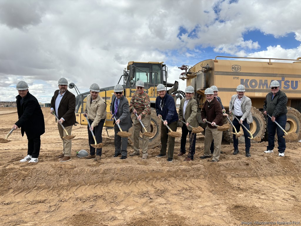 row of men with shovels at a groundbreaking event